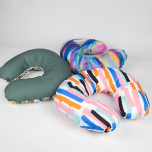 Polyester fabric travel pillow with filling flakes